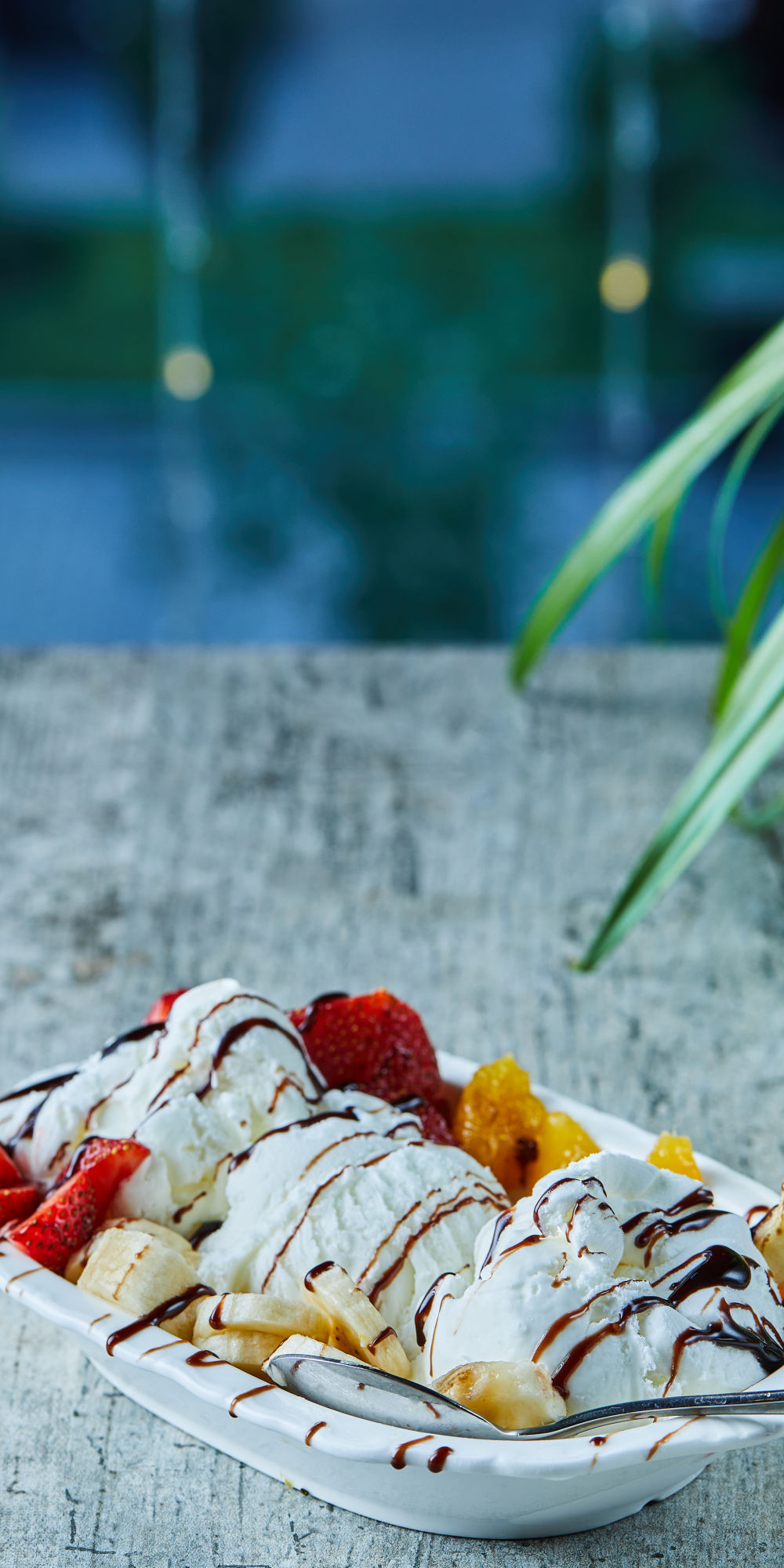 ice-cream-with-strawberry-banana-orange-white-plate-with-spoon